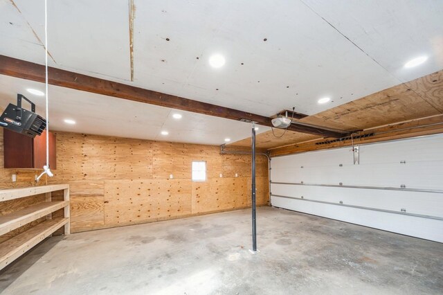garage with recessed lighting and a garage door opener