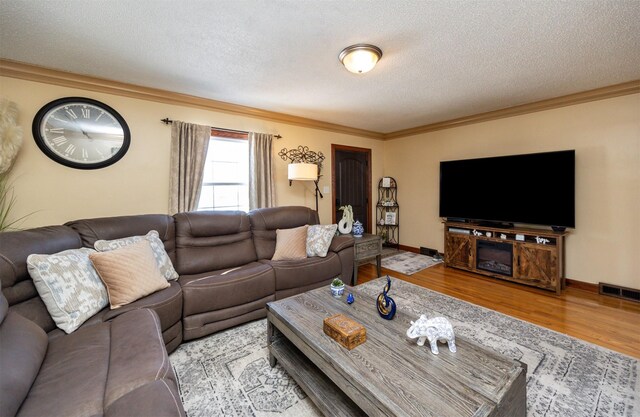 2711 Westover Blvd, Des Moines, IA 50322 - living area featuring crown molding, a textured ceiling, and wood finished floors