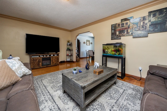2711 Westover Blvd, Des Moines, IA 50322 - living room featuring arched walkways, a textured ceiling, crown molding, and wood finished floors