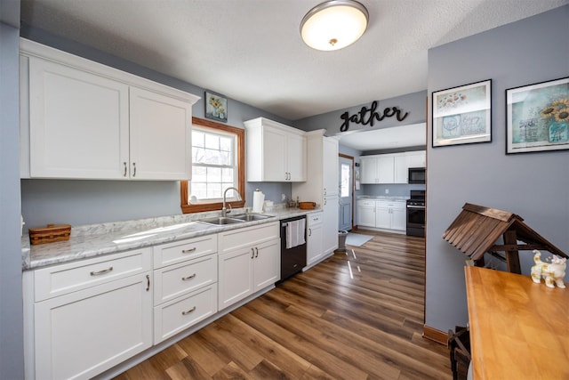 2711 Westover Blvd, Des Moines, IA 50322 - kitchen with stove, dishwasher, black microwave, dark wood-style flooring, and white cabinets