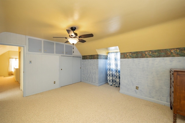 2711 Westover Blvd, Des Moines, IA 50322 - unfurnished bedroom with carpet, vaulted ceiling, wallpapered walls, and ceiling fan