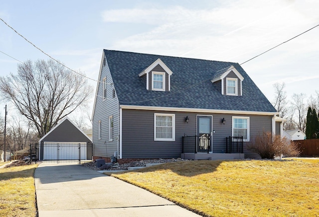 cape cod home with a front lawn, fence, roof with shingles, a garage, and an outdoor structure