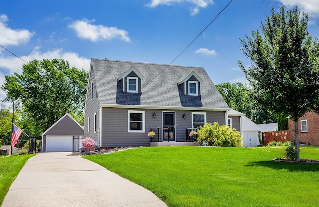 2711 Westover Blvd, Des Moines, IA 50322 - cape cod-style house featuring an outbuilding, a detached garage, a front yard, and roof with shingles