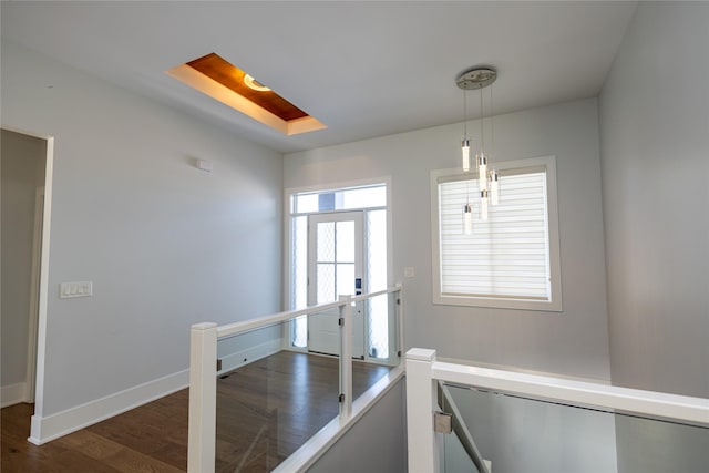 interior space featuring baseboards and wood finished floors