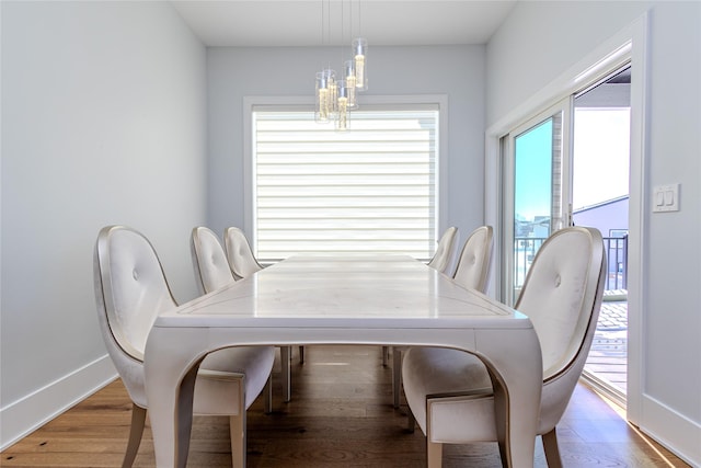 dining room featuring wood-type flooring and a notable chandelier