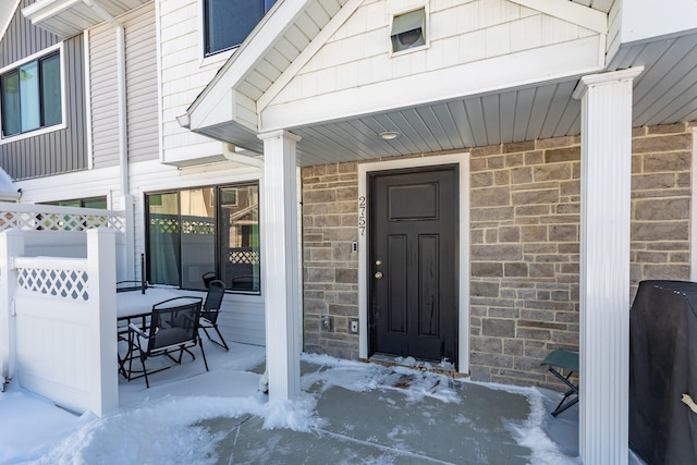 view of exterior entry with a porch