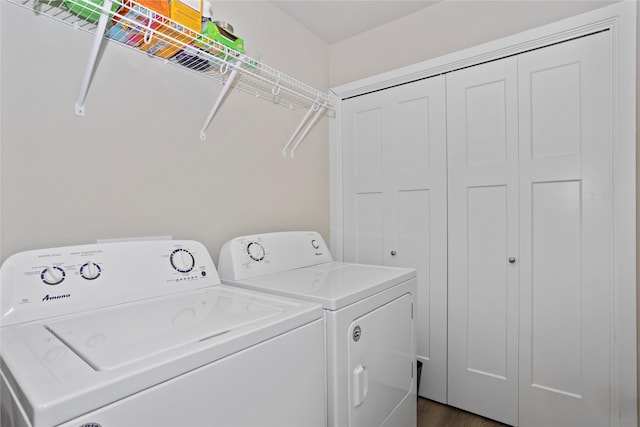 laundry area with dark wood-type flooring and washer and dryer