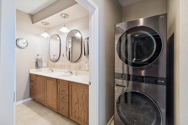 bathroom with vanity and stacked washing maching and dryer