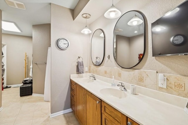 bathroom with tile patterned floors and vanity