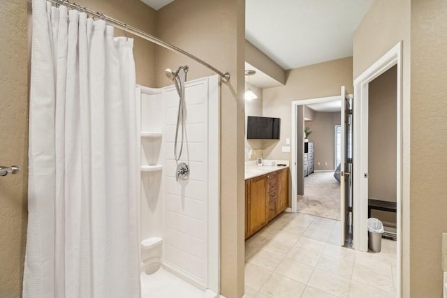 bathroom featuring tile patterned flooring, vanity, and a shower with curtain