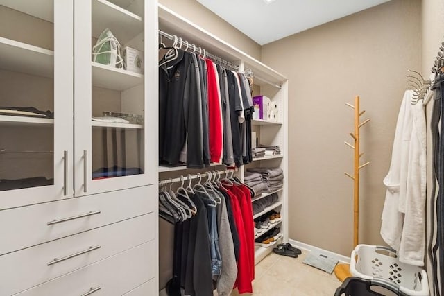 walk in closet featuring light tile patterned flooring