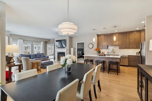 dining area featuring sink and light hardwood / wood-style floors