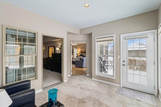 doorway to outside featuring light colored carpet