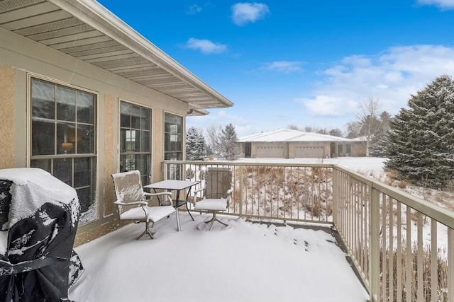 view of snow covered back of property