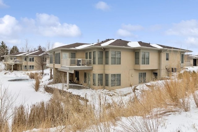 view of snow covered back of property