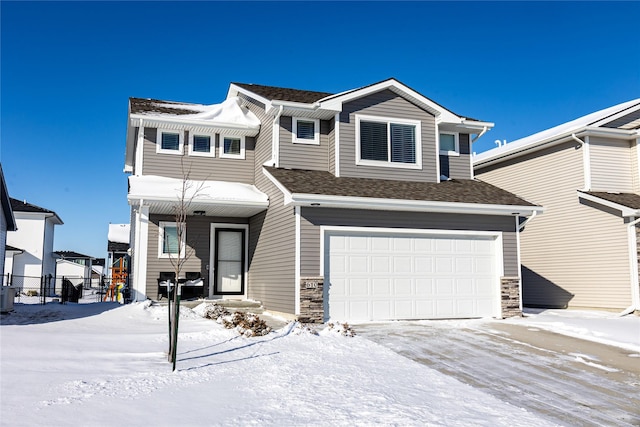 view of front of home with a garage and central air condition unit