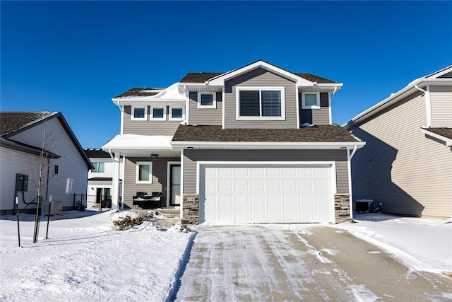 view of front of home with a garage and central air condition unit