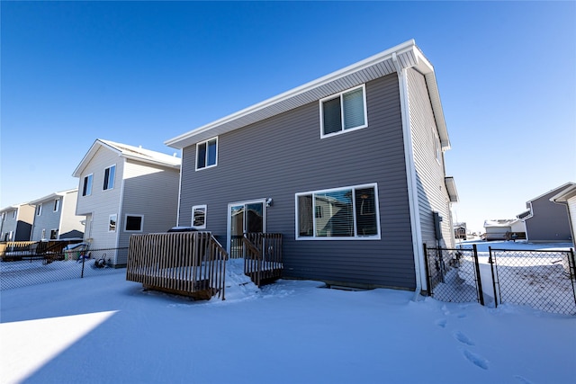 view of snow covered rear of property