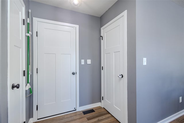 doorway with dark hardwood / wood-style flooring