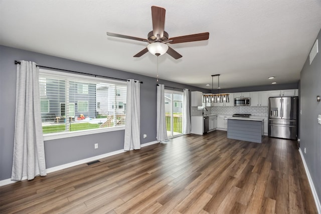 610 NE Whitetail Dr, Ankeny, IA 50021 - unfurnished living room featuring a ceiling fan, dark wood-type flooring, and recessed lighting