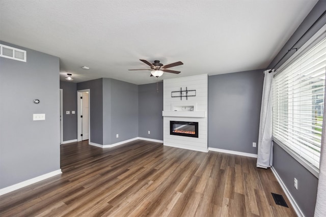 610 NE Whitetail Dr, Ankeny, IA 50021 - unfurnished living room featuring a ceiling fan, a fireplace, and wood finished floors