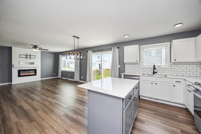 610 NE Whitetail Dr, Ankeny, IA 50021 - kitchen with light countertops, a center island, white cabinetry, ceiling fan, and recessed lighting