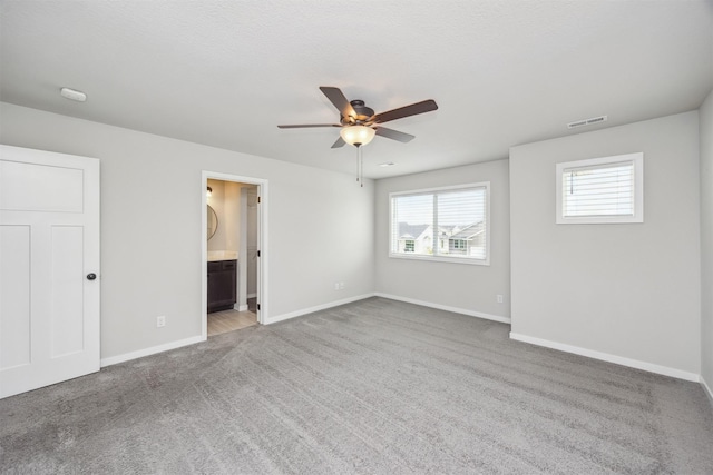 610 NE Whitetail Dr, Ankeny, IA 50021 - unfurnished bedroom featuring carpet flooring, ensuite bathroom, and a ceiling fan