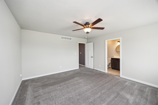 610 NE Whitetail Dr, Ankeny, IA 50021 - unfurnished bedroom with carpet flooring, ensuite bathroom, and a ceiling fan