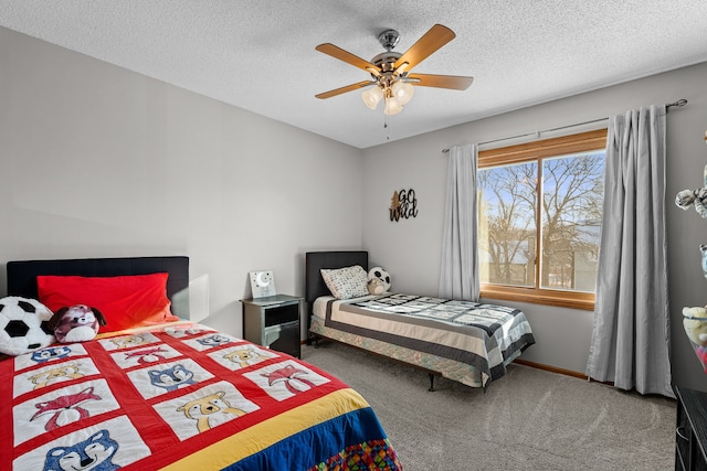 carpeted bedroom featuring ceiling fan and a textured ceiling