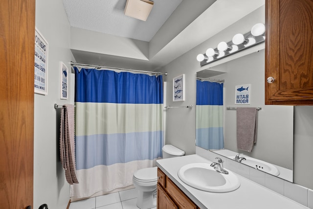 bathroom with tile patterned floors, toilet, a textured ceiling, vanity, and curtained shower