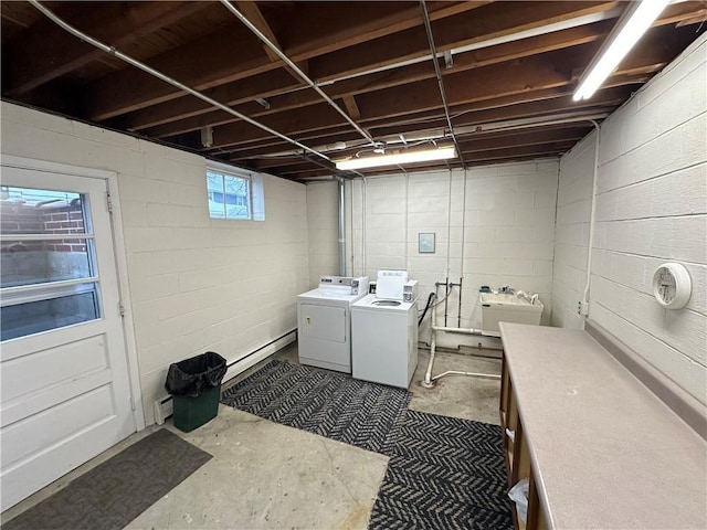 washroom featuring laundry area, a sink, and washing machine and clothes dryer