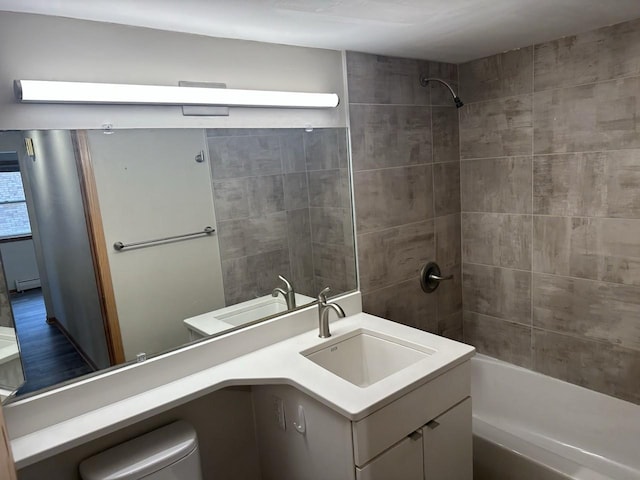 full bath with baseboard heating, toilet, vanity, and shower / tub combination