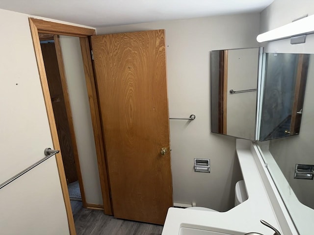 bathroom with wood finished floors and toilet