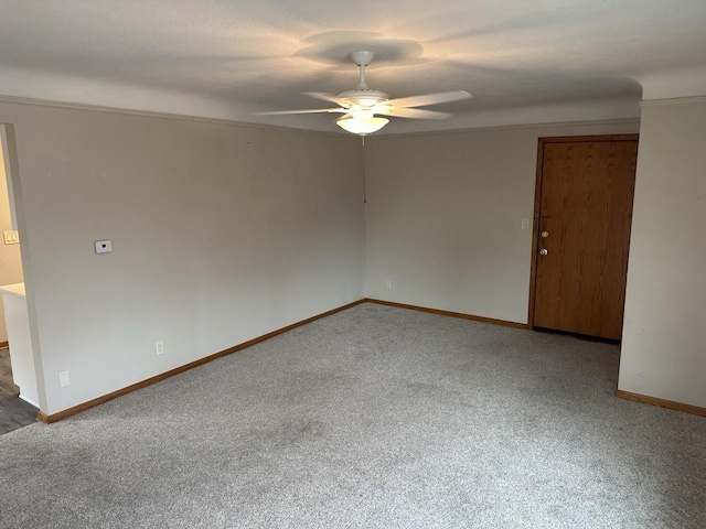 spare room featuring carpet flooring, ceiling fan, and baseboards