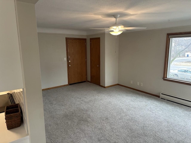 unfurnished room with light carpet, baseboards, ceiling fan, a textured ceiling, and a baseboard heating unit