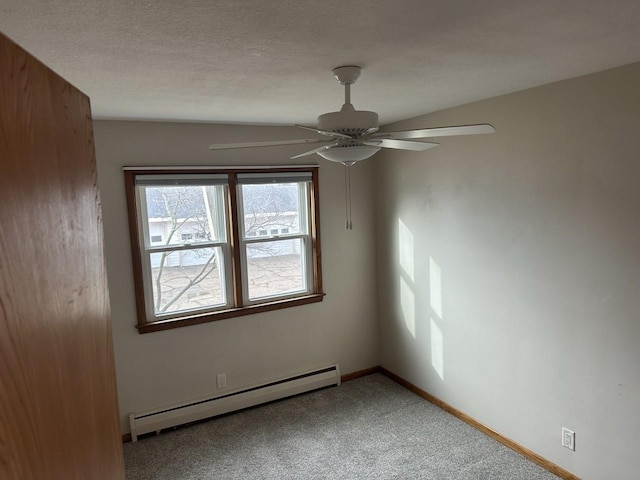 spare room featuring baseboards, a ceiling fan, light colored carpet, a baseboard radiator, and a textured ceiling