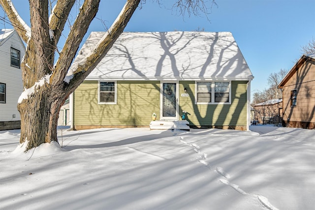 view of snow covered rear of property