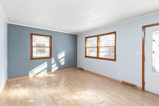 empty room with light hardwood / wood-style flooring, a healthy amount of sunlight, and baseboard heating