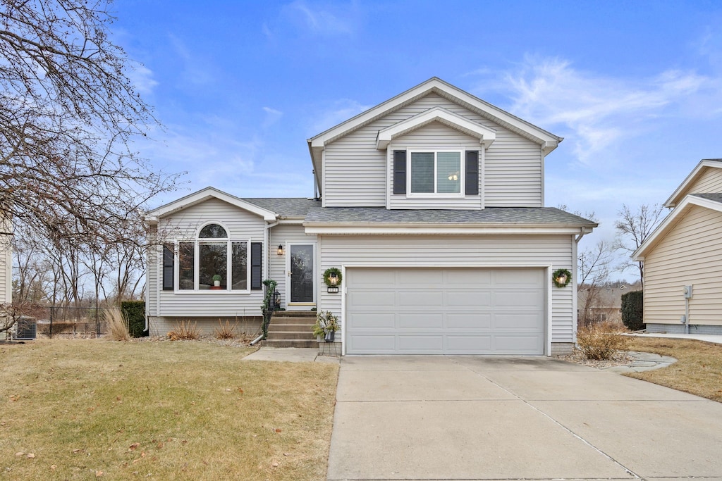 view of front of house featuring a garage and a front lawn