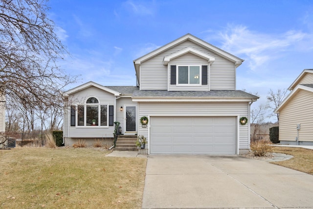 view of front of house featuring a garage and a front lawn