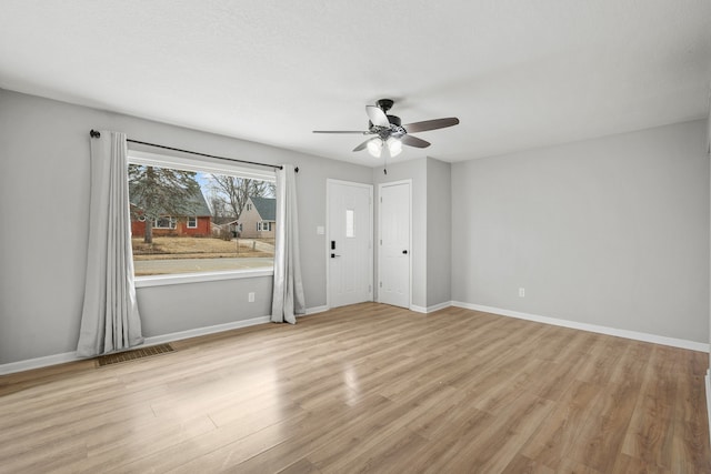 unfurnished room featuring ceiling fan and light wood-type flooring