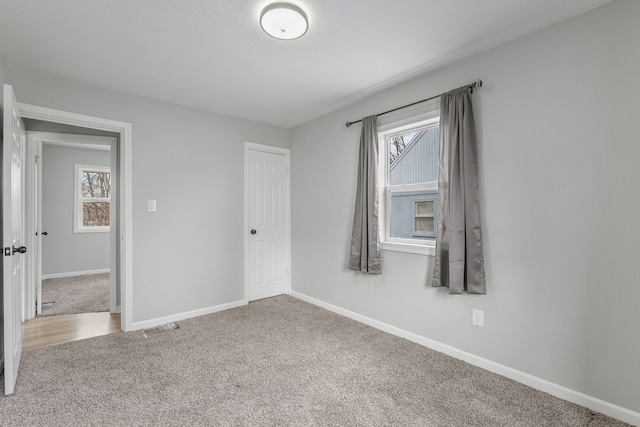 unfurnished bedroom with a closet and carpet flooring