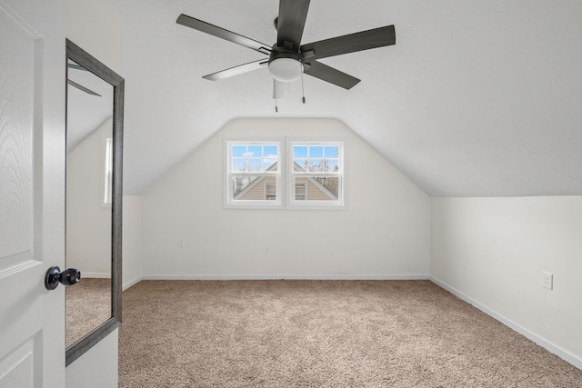 additional living space featuring ceiling fan, lofted ceiling, and carpet floors