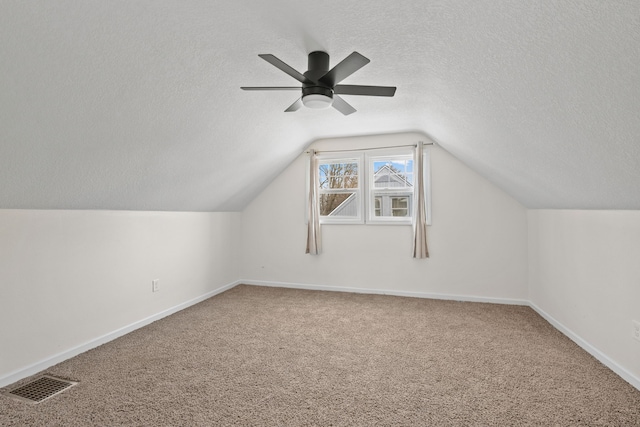 bonus room with lofted ceiling, ceiling fan, a textured ceiling, and carpet flooring