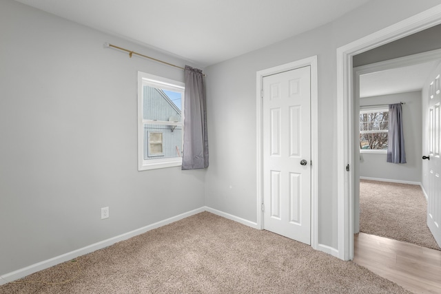 unfurnished bedroom featuring light carpet