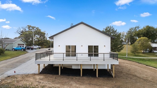 back of house with a wooden deck