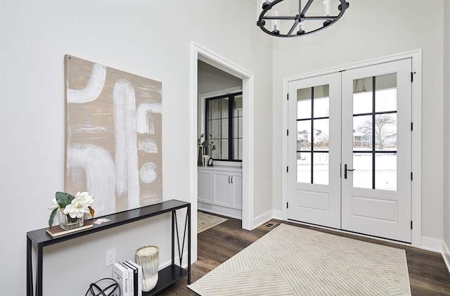 foyer featuring dark wood-type flooring and french doors