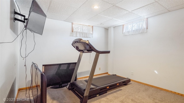 exercise room with carpet floors and a paneled ceiling