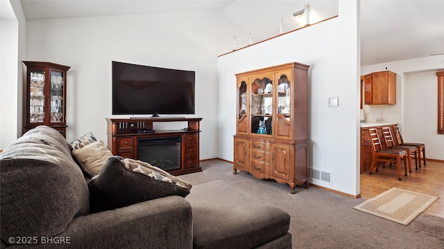 living room with lofted ceiling and light carpet