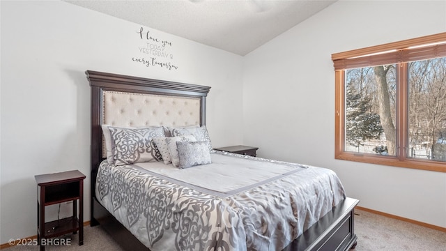 bedroom with carpet floors and vaulted ceiling